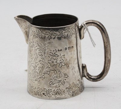 Lot 309 - A small silver jug, having foliate engraved...