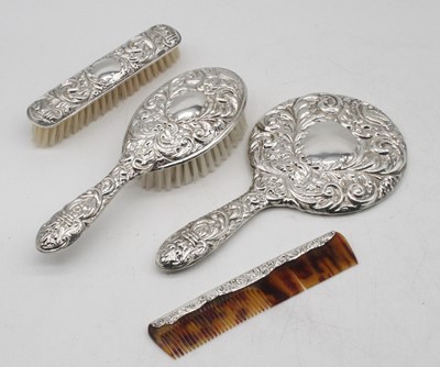 Lot 310 - A 1970s silver mounted four-piece dressing...