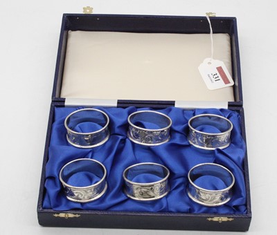 Lot 331 - A set of six modern silver napkin rings, each...