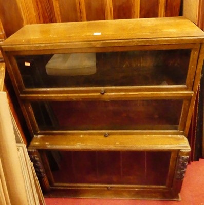 Lot 1144 - A 1930s moulded oak bookcase, having three...