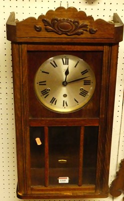 Lot 1168 - A 1930s oak droptrunk wall clock, with...