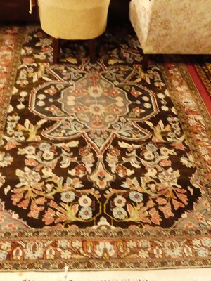 Lot 1175 - A Persian woollen brown ground Tabriz rug, 300...