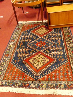 Lot 1182 - A Persian woollen red and blue ground Shiraz...