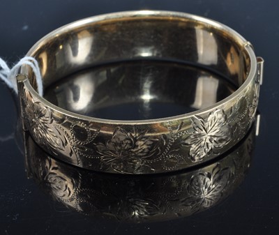 Lot 396 - A 9ct gold and metal core hinged bangle with...