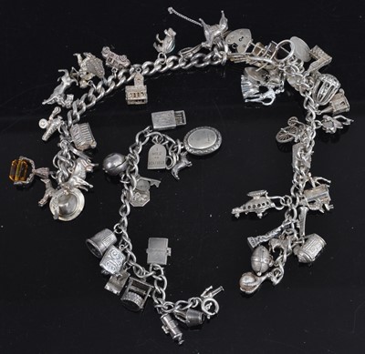 Lot 468 - A silver curb link bracelet containing a large...