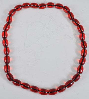 Lot 473 - A beaded faux cherry amber necklace, 80cm