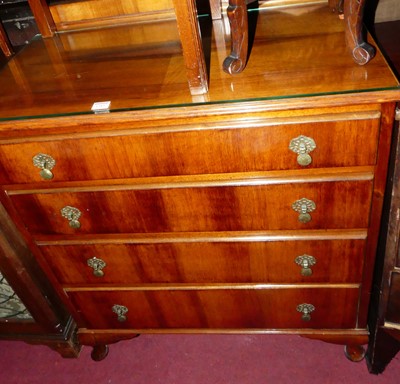 Lot 1285 - A 1920s walnut ledgeback chest of four long...