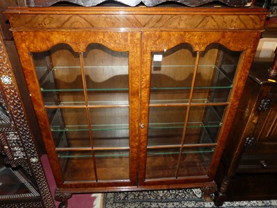 Lot 1302 - A 1930s figured walnut double door glazed...