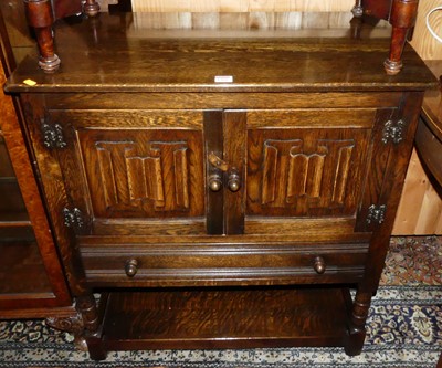 Lot 1304 - A contemporary moulded oak linenfold double...