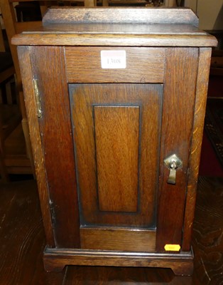 Lot 1308 - An oak single door table-top tobacco cabinet,...