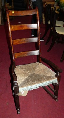 Lot 1333 - A fruitwood and rush seat country ladderback...