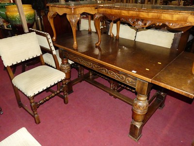 Lot 1335 - A carved oak drawleaf refectory dining table,...