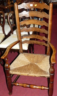 Lot 1383 - A country elm and rush seat ladder back open...