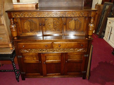 Lot 1385 - A contemporary oak court cupboard, with floral...