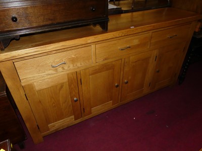 Lot 1391 - A contemporary light oak long sideboard, width...