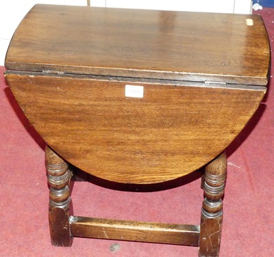 Lot 1419 - A small joined oak drop flap top occasional...