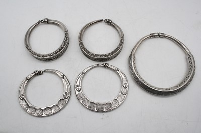 Lot 516 - A pair of Indian white metal cuff bangles,...