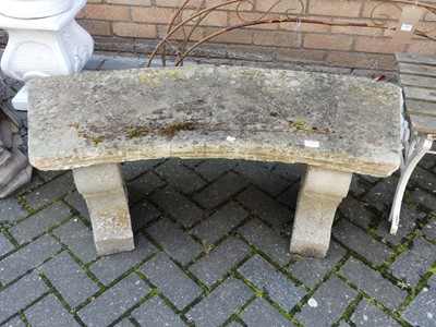 Lot 1442 - A reconstituted stone curved two-seater garden...