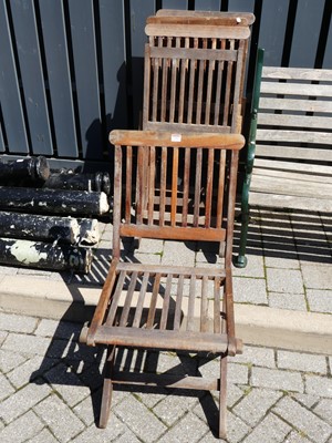 Lot 1452 - A set of four stained and slatted teak folding...