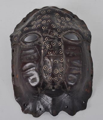 Lot 2448 - A turtle shell mask, carved with open eyes and...