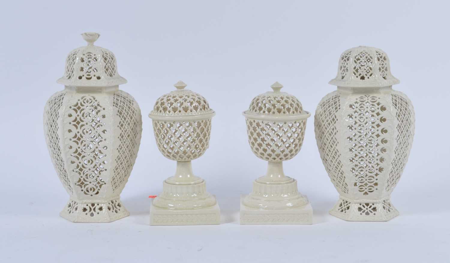 Lot 49 - A pair of creamware urns, each having pierced...