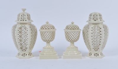 Lot 49 - A pair of creamware urns, each having pierced...