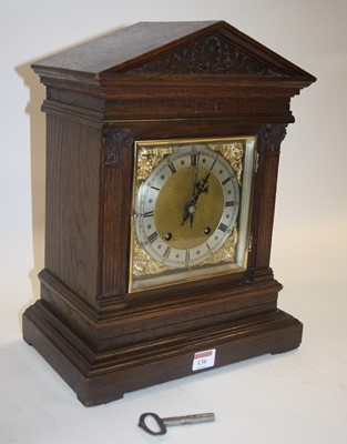 Lot 136 - A circa 1900 oak cased mantel clock, of...