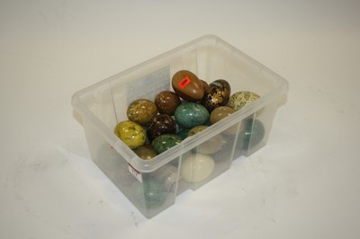 Lot 174 - A box of polished hardstone, treen, and papier-...
