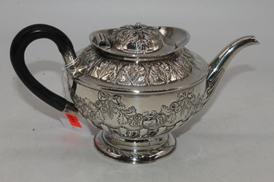 Lot 253 - A Victorian silver teapot, repousse decorated...