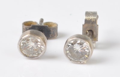 Lot 2200 - A pair of white metal diamond stud earrings,...