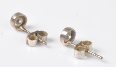 Lot 2201 - A pair of white metal diamond stud earrings,...