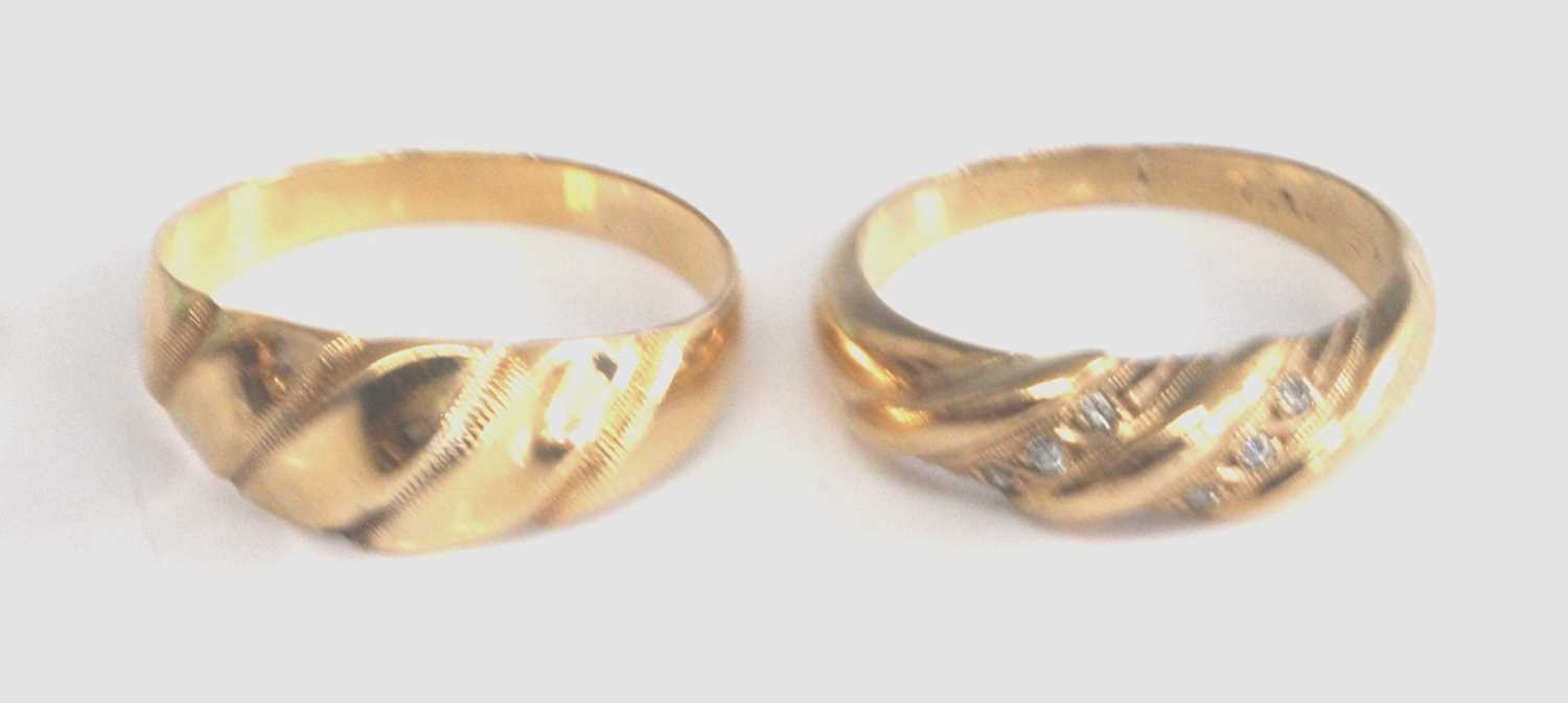 Lot 2515 - Two yellow metal dress rings, the first in a...