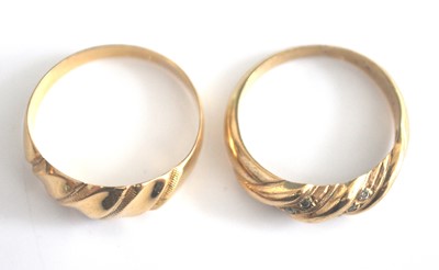 Lot 2515 - Two yellow metal dress rings, the first in a...