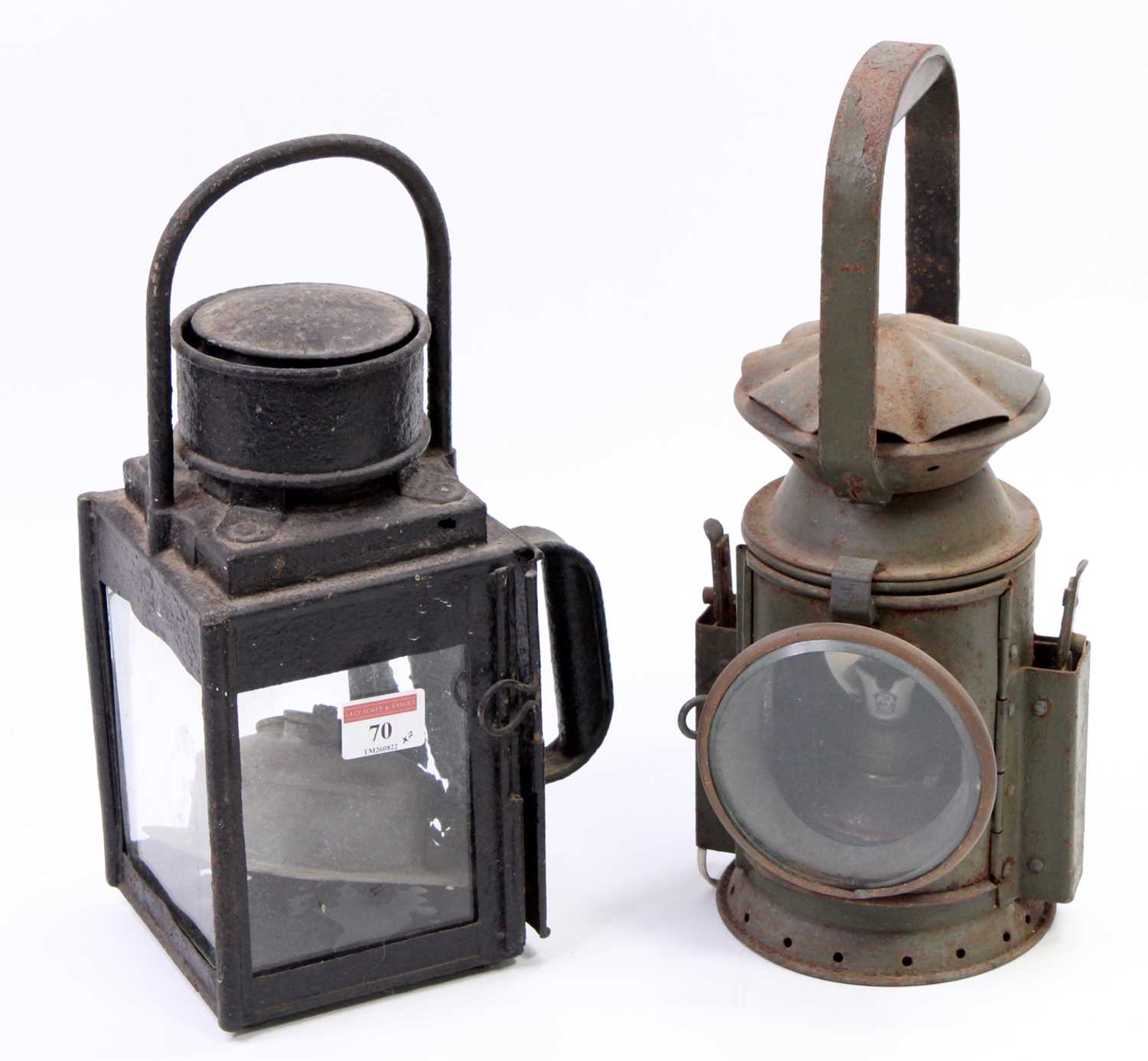 Lot 70 - Two railway lamps, to include a military green...