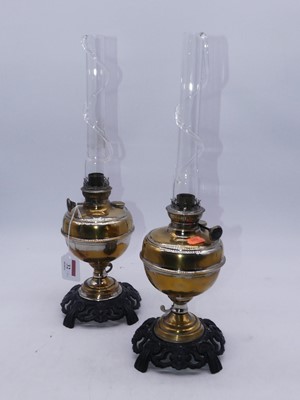 Lot 32 - A pair of 20th century eastern brass oil lamps,...