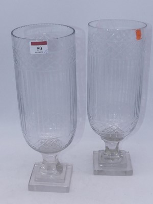 Lot 50 - A pair of modern cut glass storm lamps, each...