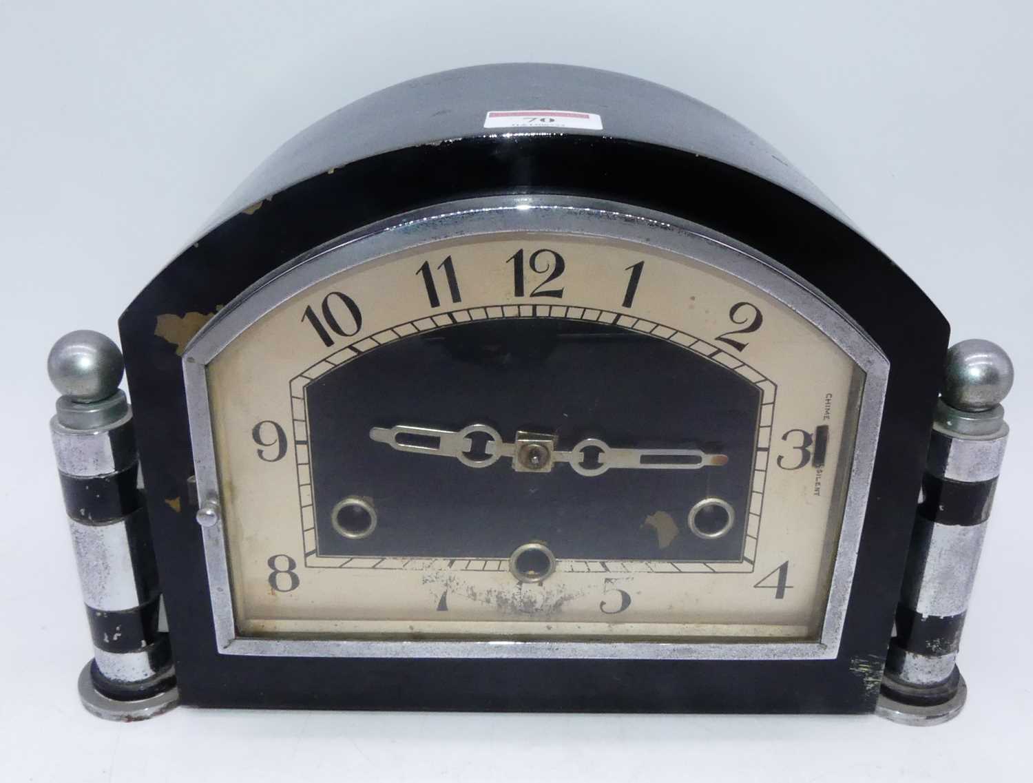 Lot 70 - An Art Deco mantel clock, having ebonised and...
