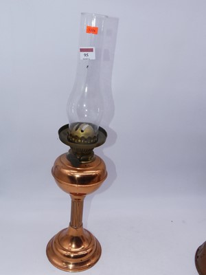 Lot 95 - An early 20th century copper pedestal oil lamp;...