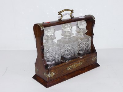 Lot 157 - A 1920s oak and brass mounted tantalus,...