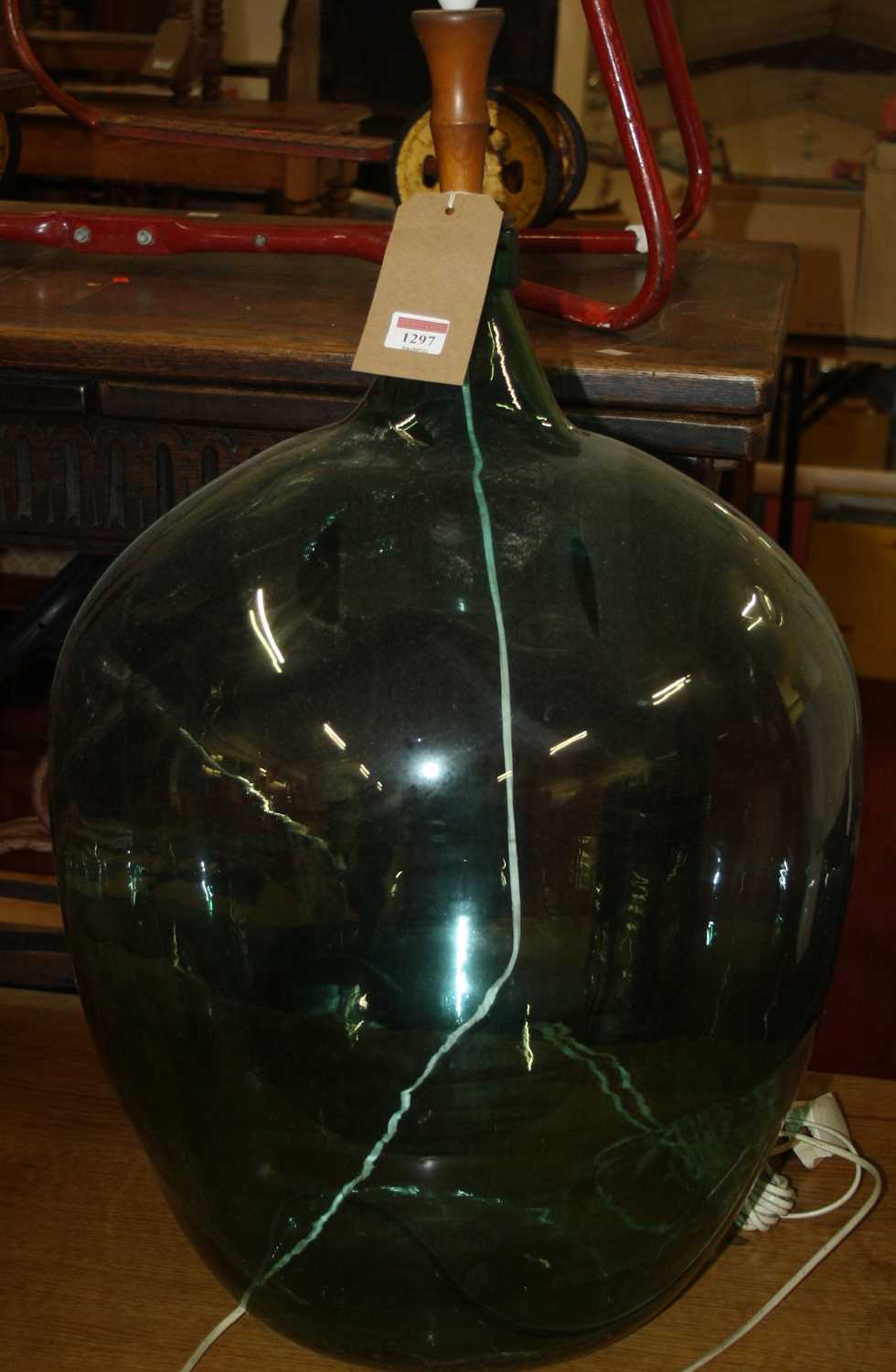 Lot 1297 - A large green glass carboy, converted to a...