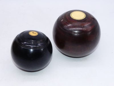 Lot 187 - A pair of lignam vitae lawn bowls; together...