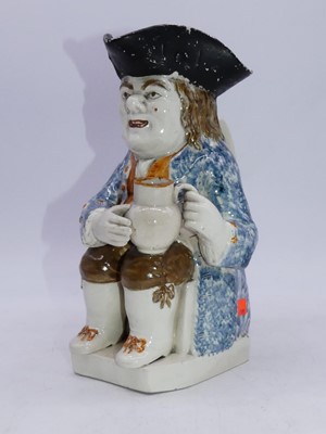 Lot 210 - An 18th century pearlware toby jug in typical...