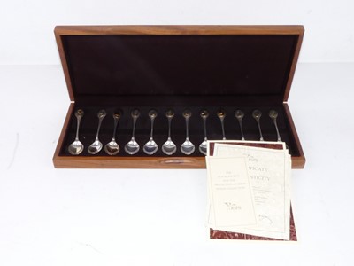 Lot 289 - A cased set of 12 silver spoons each terminal...