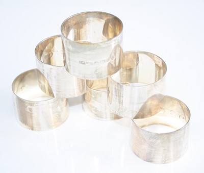 Lot 206 - A set of six contemporary silver napkin rings,...