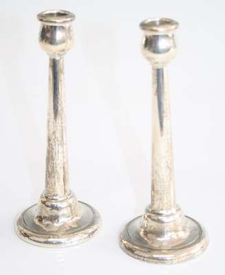Lot 174 - A pair of Art Deco silver candlesticks, each...