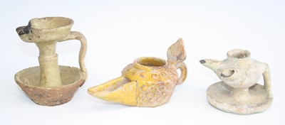 Lot 2465 - A yellow tin glazed pottery oil lamp, the body...