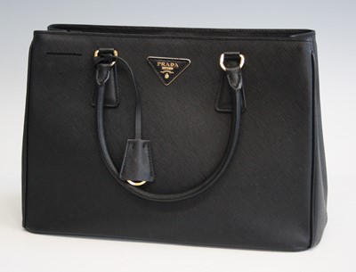 Lot 252 - A Prada black canvas handbag, having twin...