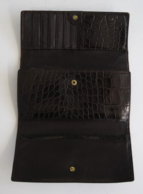 Lot 254 - A Versace crocodile skin wallet, with button...
