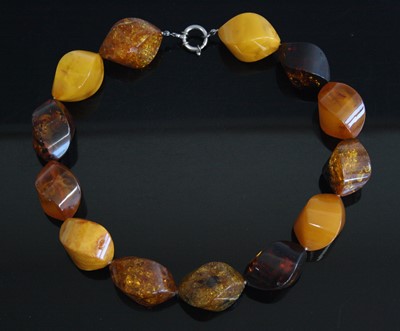 Lot 243 - A contemporary treated amber heavy beadwork...