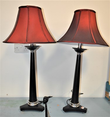 Lot 100 - A pair of modern ebonised table lamps, each...